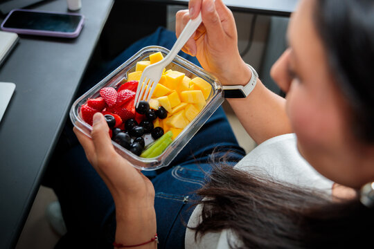 Woman Taking Fresh Fruit Snack During Office Break