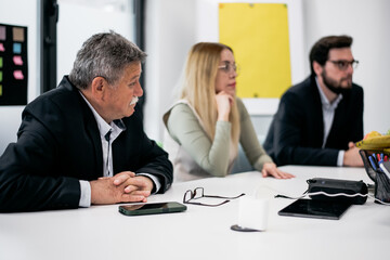 Fototapeta premium Team members attentively participating in a collaborative business meeting in a modern office setting