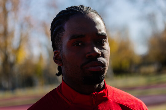 Athlete in a sports complex, displaying a concentrated expresssion