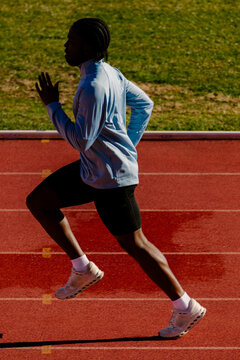 Complete view of a sprinter running at maximum speed along the track