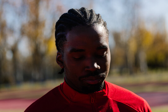 Focused athlete at an outdoor sports complex displaying determination