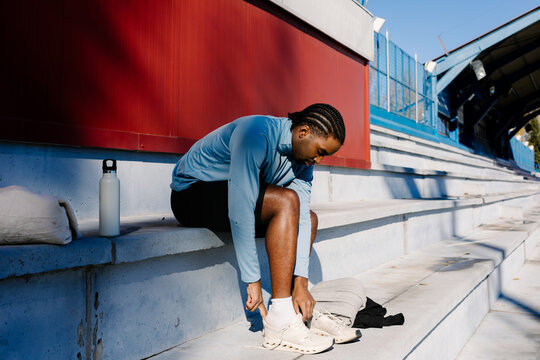 Athlete ensuring his footwear is properly set before training