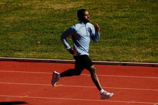 Trained runner working through fast sprint drills on the track