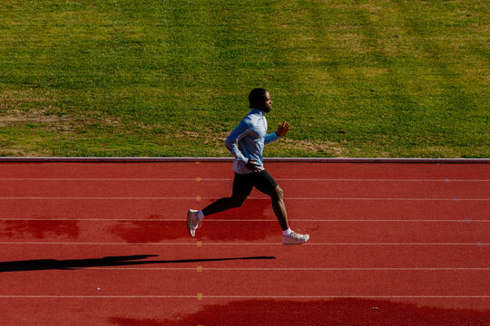 Professional athlete sprinting with extended strides