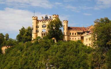 Obraz premium Historic Castle on Hill Surrounded by Trees – Castle Schwangau - Germany
