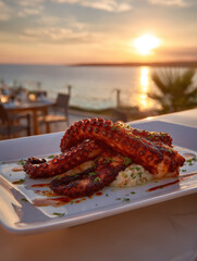 Fototapeta premium Octopus Tentacles Grilled on Plate with Sunset Ocean Background