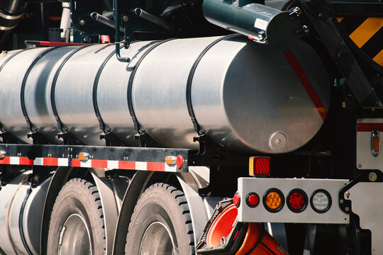 Truck With Metal Tank Parked on the Side of the Road in a City