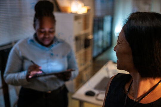 Two women working together in an office setting.