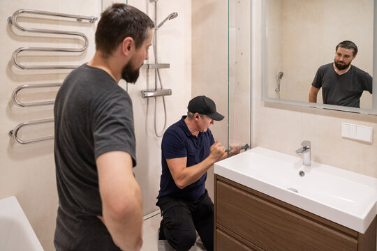Men Working on Shower Door Installation 
