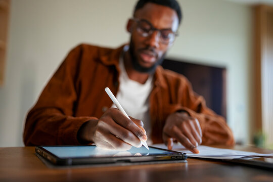 Writing on a tablet in a home setting
