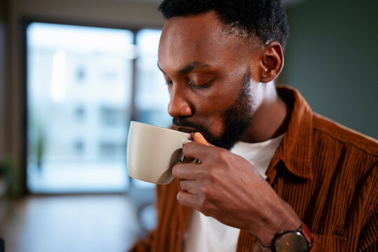 Man drinking coffee in modern setting
