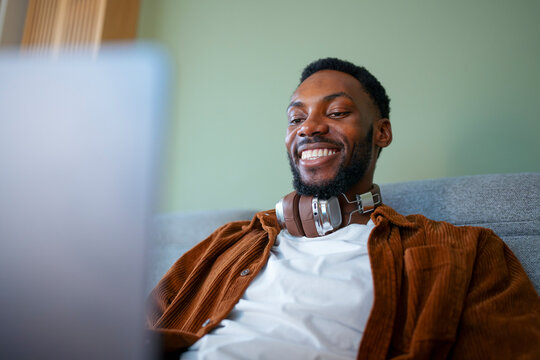 Man enjoying time using laptop at home
