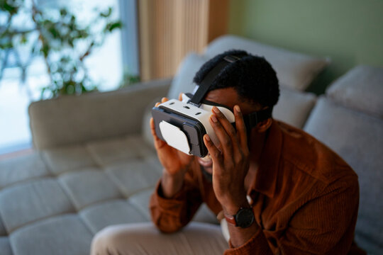 Man uses virtual reality headset at home
