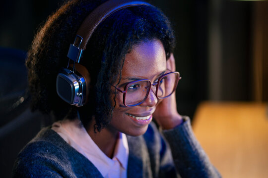 Woman listens to music while working
