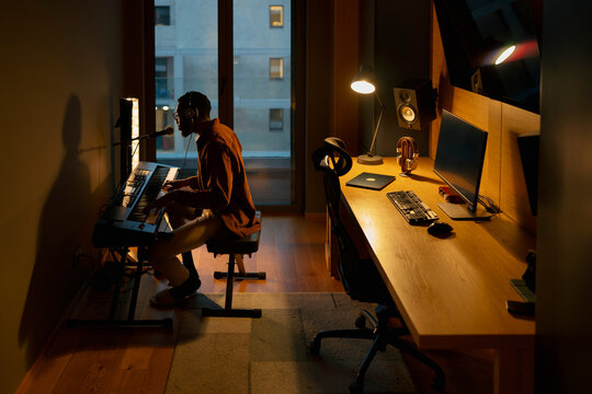 Musician plays keys at home
