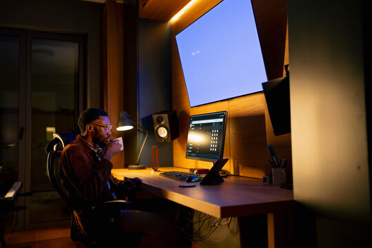 Man at computer desk at night
