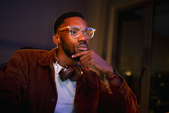 Person thinking while working at night
