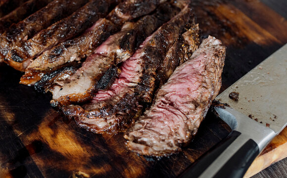 Slices of beef steak on a wooden board