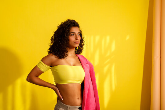 Woman Poses  in a Bright Yellow Room