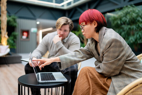 Business colleagues collaborating on project in office
