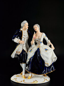 Porcelain figurine depicting a man and a woman standing together. Elegant decorative sculpture with delicate details, classic style, and smooth white porcelain surface, suitable for home decor or coll