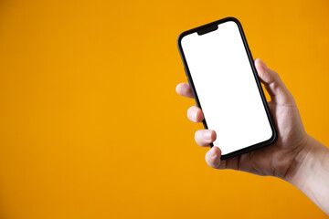 Person holding a modern mobile phone with a transparent screen png, isolated on a yellow background