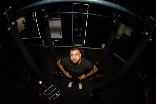 Man preparing to lift weights in gym during workout session