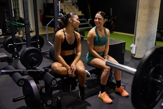 Women exercise together in gym during workout session