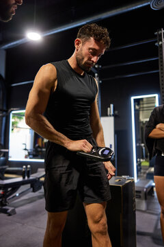 Man using scale in gym during workout session