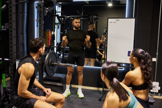 People learn workout techniques in gym session with trainer