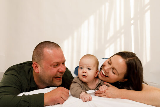 Family Enjoys Time Together in a Simple Indoor Setting With a Child