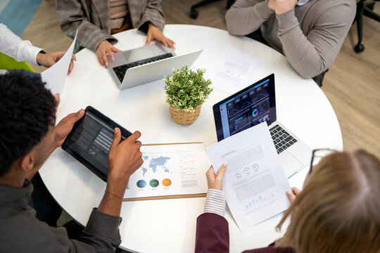 Business colleagues collaborating on data analysis during meeting