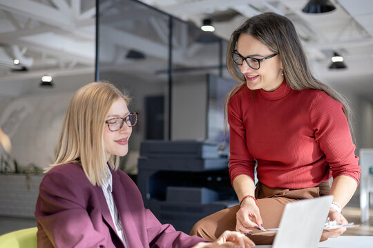 Business colleagues collaborating on project in office