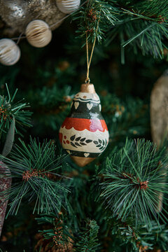 Handcrafted Christmas Ornament Hanging From Pine Branches 