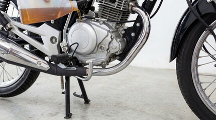 Motorcycle engine and wheel close-up on a clean studio floor