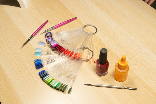 Nail polish display with tools on wooden table