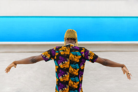 Back view of man in Nigerian print shirt