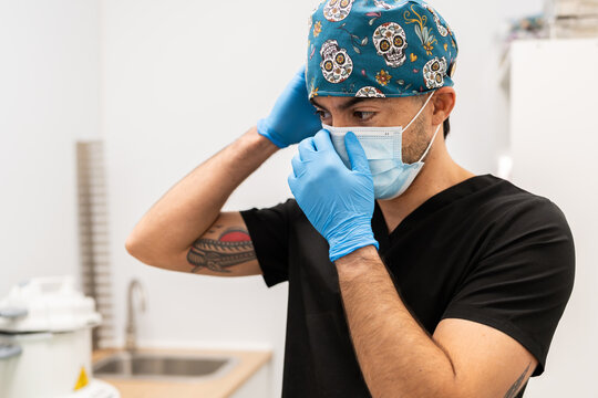 Veterinarian preparing for work wearing mask and gloves
