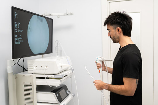 Veterinarian preparing endoscopy equipment for diagnostic procedure