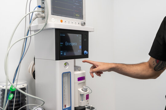 Veterinarian using medical anesthesia machine in hospital