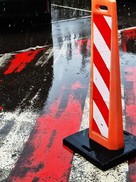 Road cones and wet pavement in a city street