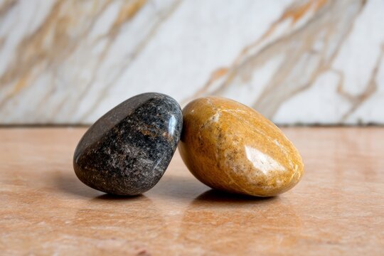 Friction Difference Between Smooth Stones Sliding on Surface for Physics Concept Demonstration