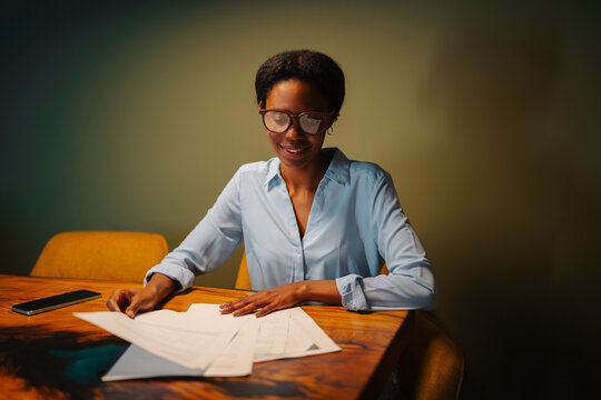 Woman working at a wooden table
