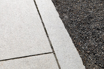 Obraz premium Stone curb beside gravel and pavement