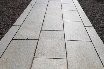 Fototapeta premium Stone curb beside gravel and pavement