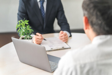Fototapeta premium Young Asian businessman and female customer serving in showroom/negotiation space