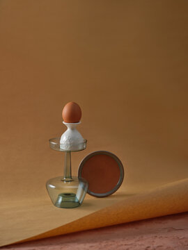 A modern still life composition showcasing an egg and plate