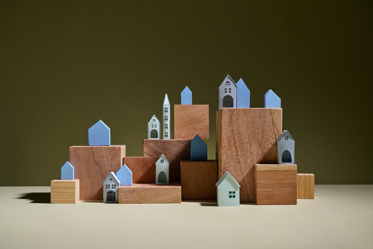 A whimsical arrangement of tiny houses on wooden blocks