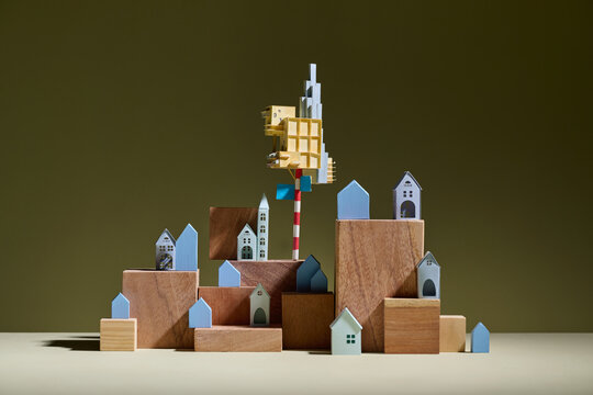 A creative composition of miniature houses arranged on wooden blocks