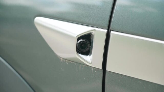 Slow Motion shot of a side camera and ADAS sensor mounted on a modern electric vehicle in China. An advanced driver assistance system supporting vehicle safety and environmental awareness.